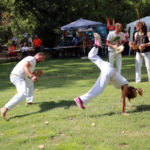 menino menina jogando capoeira berimbau